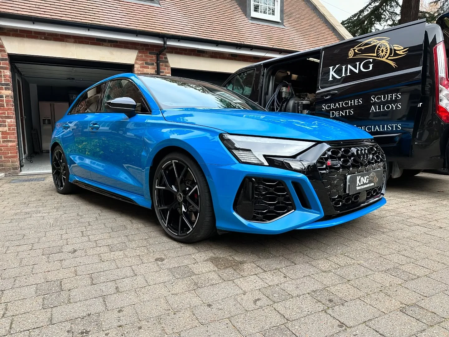 Bright blue Audi beside the branded King mobile repair van